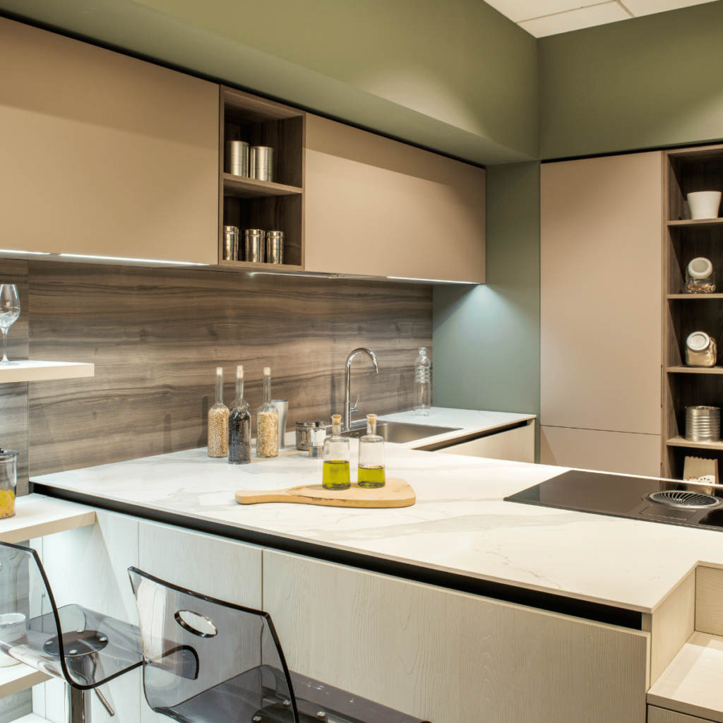 Modern kitchen with beige cabinets, wood accents, and marble countertops.
