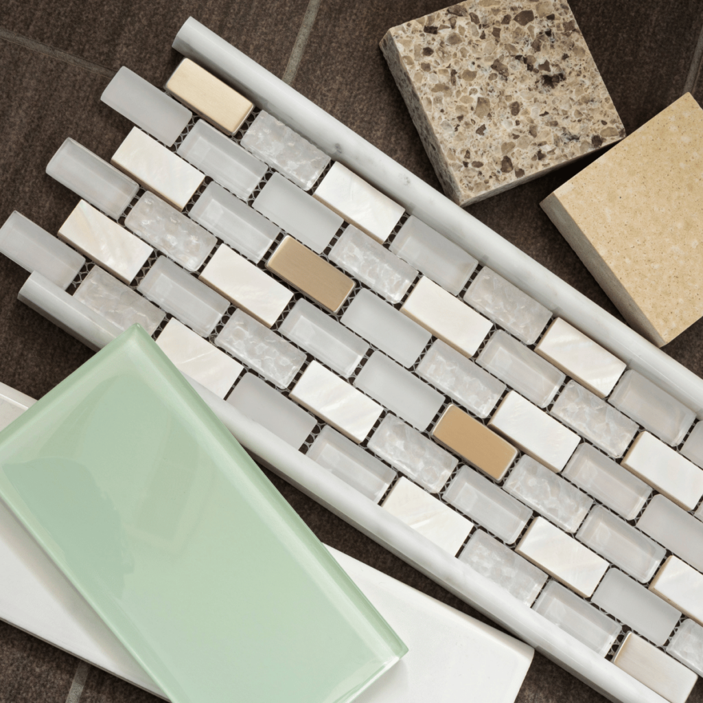 Assorted bathroom tile samples including mosaic, stone, and glass pieces.