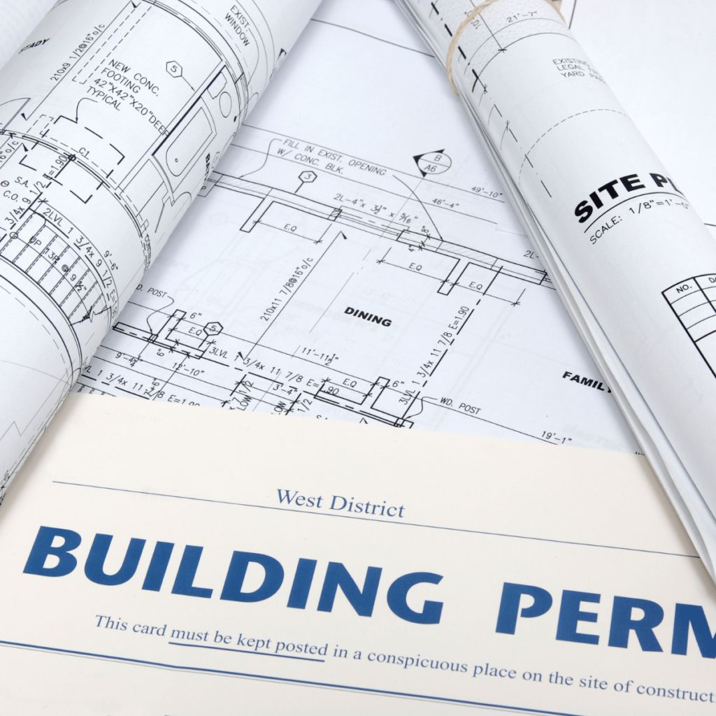 Rolled architectural blueprints with a visible building permit from the West District.