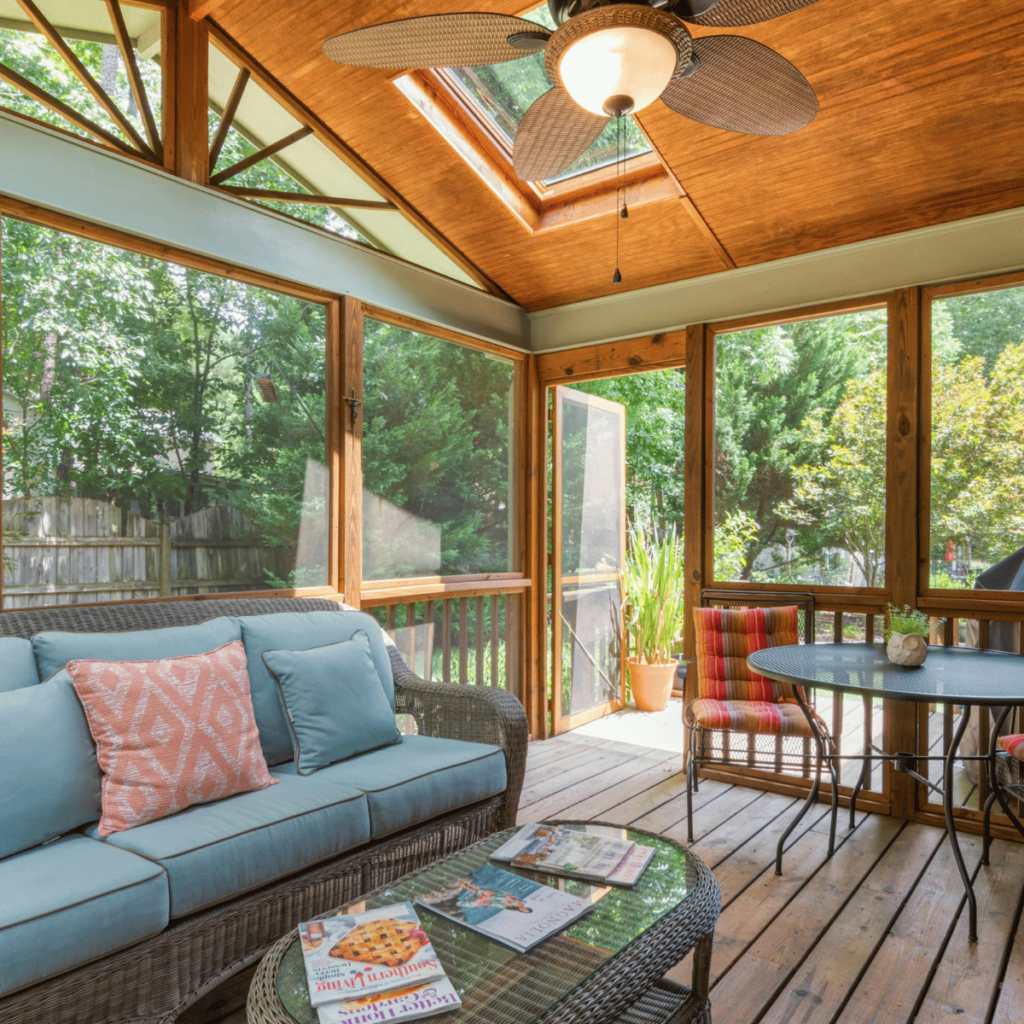 Cozy sunroom with wicker furniture, skylight, and wooden ceiling.