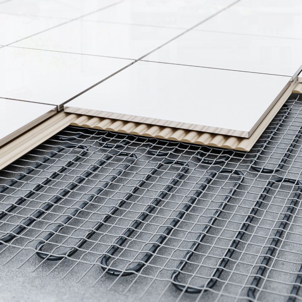 Heated bathroom floor system under white tile installation.