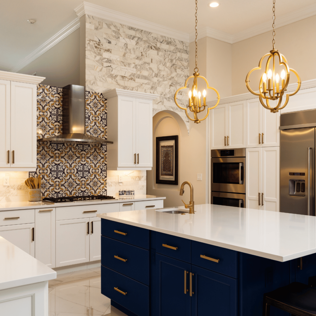 Kitchen with white cabinets, navy island, and patterned tile backsplash.