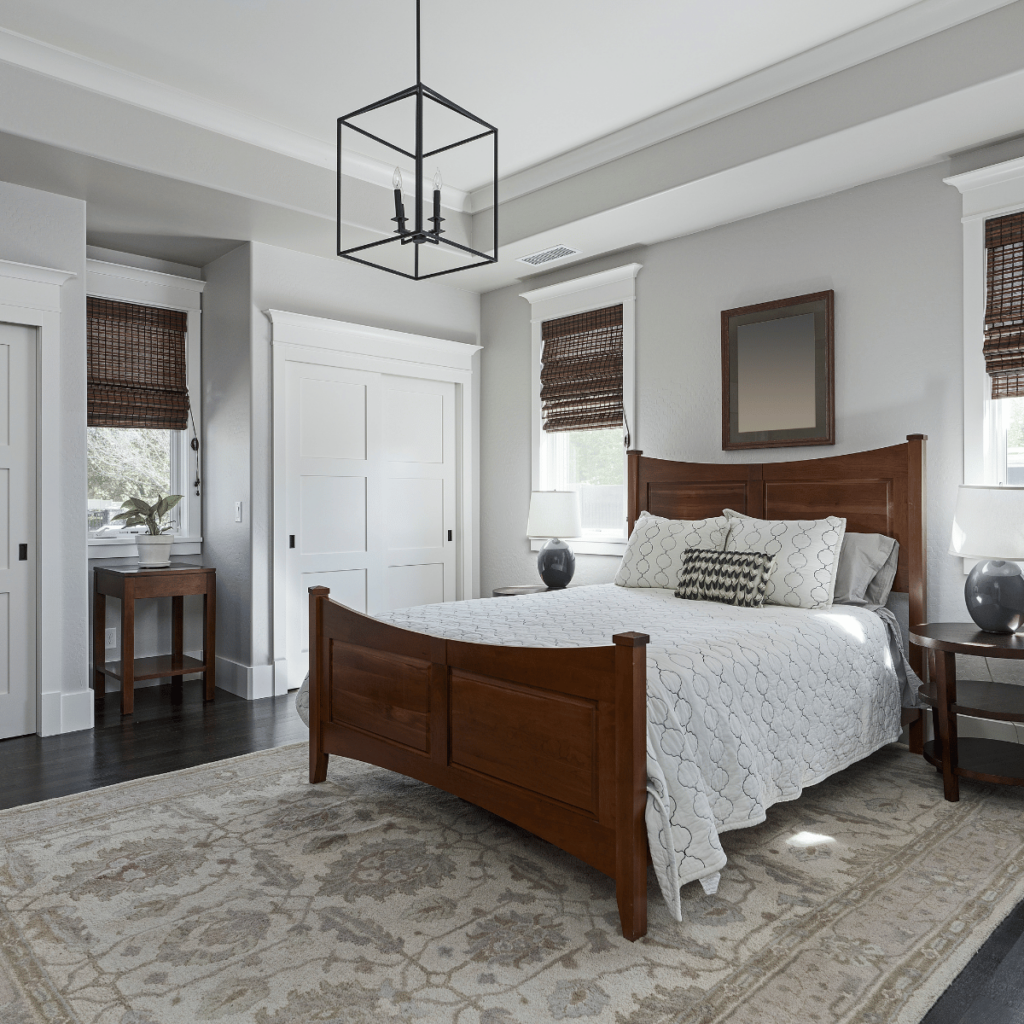 Master bedroom in a second story addition with wood bed and neutral decor.